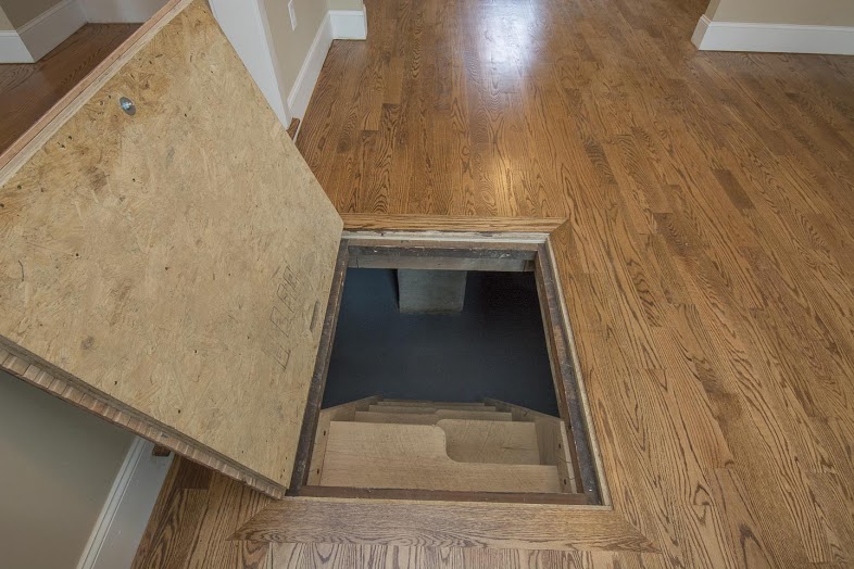 Secret hardwood floor hatch that heads to basement.