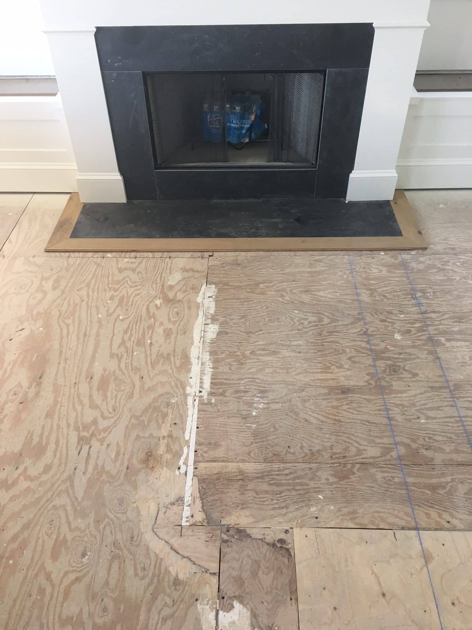 Wooden floor with a white and black chimney on the wall